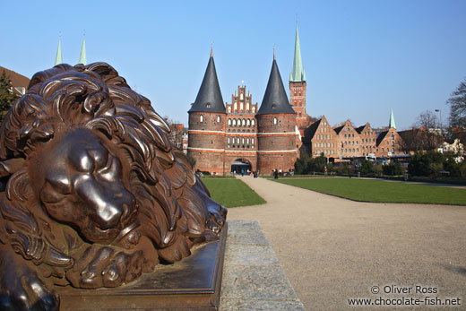 Resting lion outside Lübeck`s Holstentor (city gate)