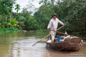 Travel photography:Floating merchant in a Mekong tributary near Can Tho , Vietnam