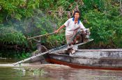 Travel photography:Boy driving a boat near Can Tho , Vietnam