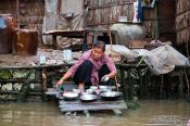 Travel photography:Washing the dishes in the Mekong near Can Tho , Vietnam