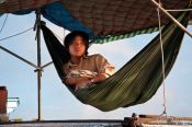 Travel photography:Having a rest aboard his ship near Can Tho, Vietnam