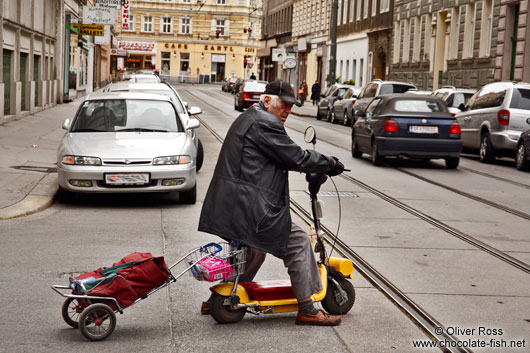 Man on a small scooter in Vienna 