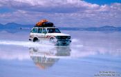 Travel photography:Crossing the flooded Salar de Uyuni (Uyuni saltflat) is possible in a 4WD only, Bolivia