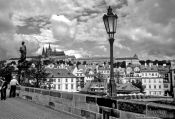Travel photography:Houses along the Lesser Quarter with castle at the top, viewed from Charles bridge, Czech Republic