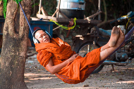 Buddhist monk with headphones near Angkor Thom