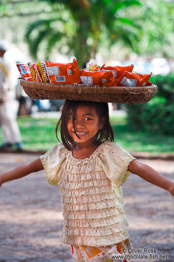 Little girl selling food outside Wat Phnom in Phnom Penh