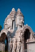 Travel photography:Giant faces above one of the entrance gates to the Vipassara Dhara Buddhist Centre near Odonk (Udong), Cambodia