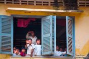 Travel photography:Kids waving out from their school window, Cambodia