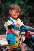 Travel photography:Small boy along the Stung Sangker river near Battambang, Cambodia