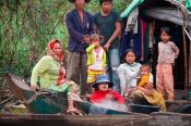 Travel photography:Family on their boat on the Stung Sangker river near Battambang, Cambodia