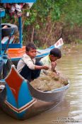 Travel photography:Boys fishing near the Tonle Sap Lake, Cambodia