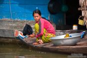 Travel photography:Girl doing the dishes in the Stung Sangker river, Cambodia