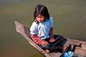 Travel photography:Small girl in boat near Tonle Sap lake, Cambodia
