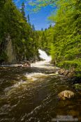 Travel photography:River in Quebec´s Mont Tremblant National Park with Chute du diable waterfall in the background, Canada