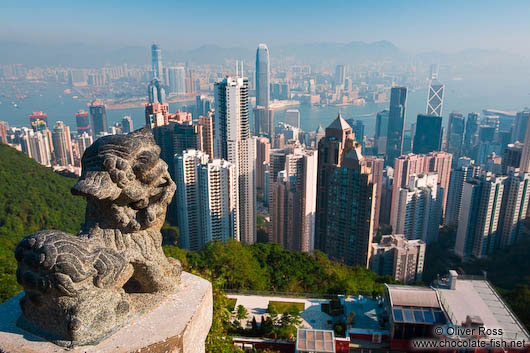 View of the Hong Kong skyline and bay with Chinese stone lion 