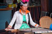 Travel photography:Girl with traditional Naxi dress weaving in Lijiang, China