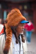 Travel photography:Man with fur hat in Lijiang, China