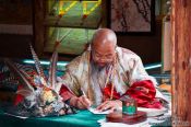 Travel photography:Lijiang man writing , China