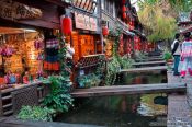 Travel photography:Channel with wooden bridges in Lijiang´s old town , China