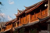 Travel photography:Lijiang traditional wooden houses with Jade Dragon Snow Mountain in the background, China