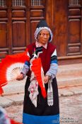 Travel photography:Naxi woman performing a traditional dance in Lijiang, China