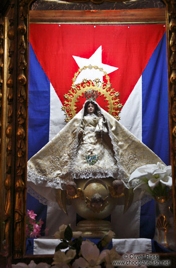 Maria statue with Cuban flag inside the Parroquia de San Juan Bautista de Remedios