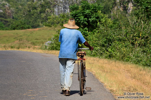 Man pushing his bike near Viñales