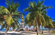 Travel photography:Palm trees with lighthouse at Cayo-Jutías beach, Cuba
