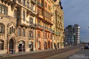 Travel photography:Houses along the Moldau (Vltava) river with the Dancing House in the background, Czech Republic