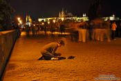 Travel photography:Beggar on Charles Bridge, Czech Republic