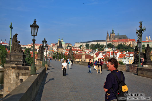 Tourists on the Charles Bridge with the Prague castle in the background