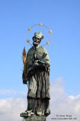 Travel photography:Bronze sculpture of St John of Nepomuk on Charles bridge, Czech Republic