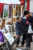 Travel photography:Passers-by browse through the art on offer in Paris´ Montmartre district, France