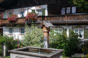 Travel photography:Traditional house with water fountain in Garmisch-Partenkirchen, Germany