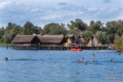Travel photography:Bathers in Lake Constance near the Neolithic stilt houses in Unteruhldingen, Germany