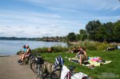 Travel photography:Bathers in Lake Constance near the Neolithic stilt houses in Unteruhldingen, Germany