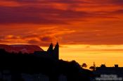 Travel photography:Silhuette of the Akureyri church in the midnight sun on midsummer night, Iceland
