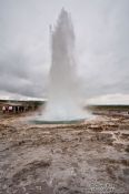 Travel photography:A geysir erupts at the Geysir Centre on the Golden Circle tourist route, Iceland