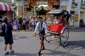 Travel photography:Rickshaw puller with tourists in Tokyo, Japan