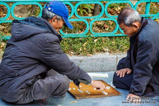 Old men playing Go in a park near the Jongmyo Royal Shrine in Seoul