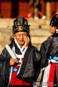 Travel photography:Man on mobile at the Jongmyo Royal Shrine in Seoul, South Korea