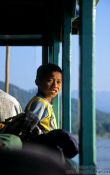 Travel photography:Boy on Mekong rive boat near Huay Xai, Laos