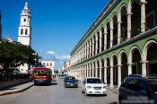 Travel photography:Colonnades along the main square in Campeche with church, Mexico