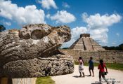 Travel photography:Snake head with pyramid at the Chichen Itza archeological site, Mexico