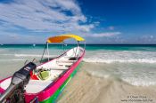 Travel photography:Tourist boat on Tulum beach, Mexico