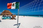 Travel photography:Volleyball net with Mexican flag at Tulum beach, Mexico