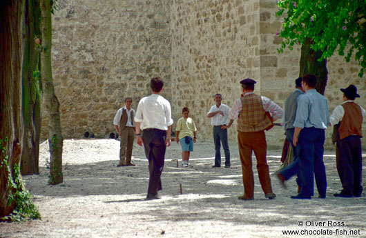 Men passing their time playing "jogo de malha"