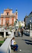 Travel photography:One of the bridges of Tromostovje (triple bridges) with the Franciscan church and Prešeren Square in Ljubljana, Slovenia