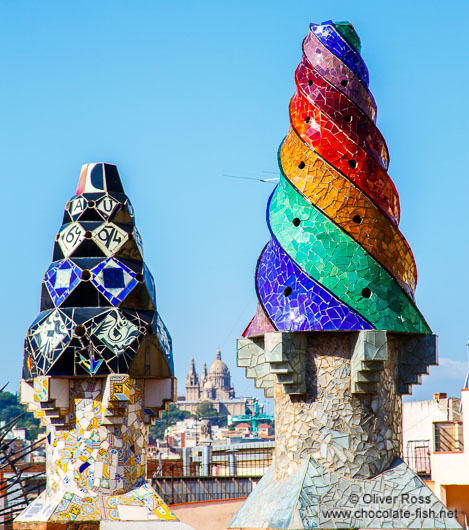 Sculpted chimneys on the roof of Palau Güell with MNAC in the background