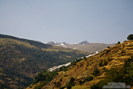 View of Capileira village with snow capped Pico Veleta in the background